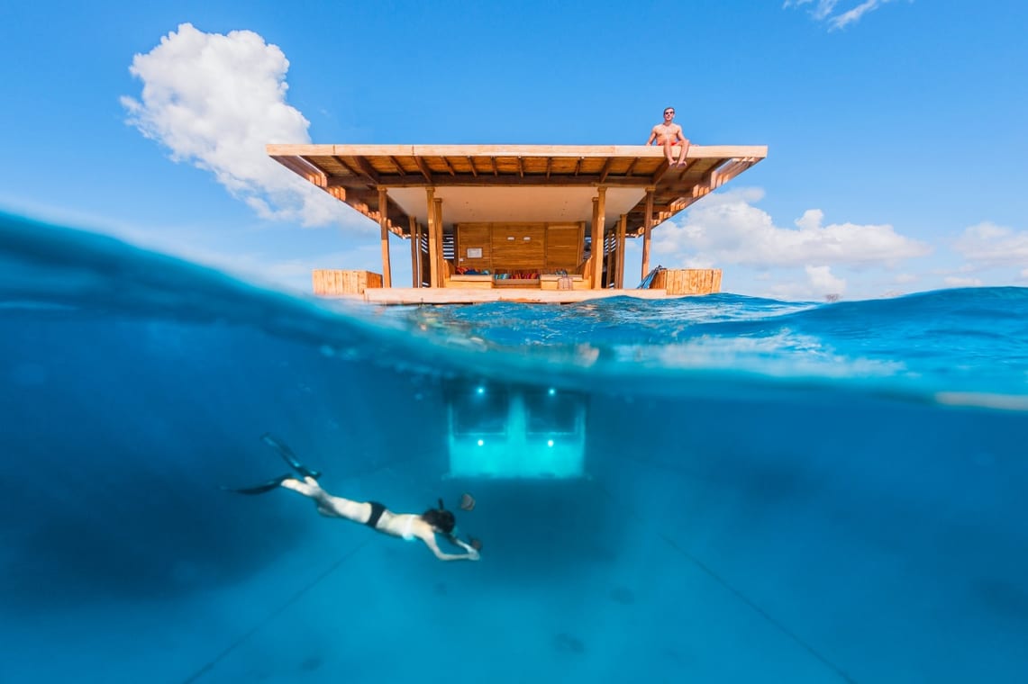 A room built on water showing you how it looks above the water level and underneath it below the water level