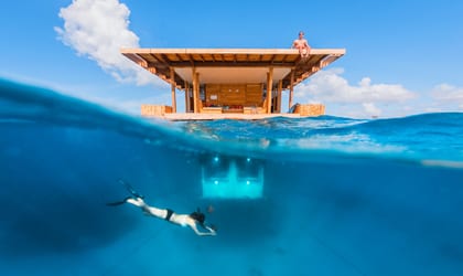 A room built on water showing you how it looks above the water level and underneath it below the water level