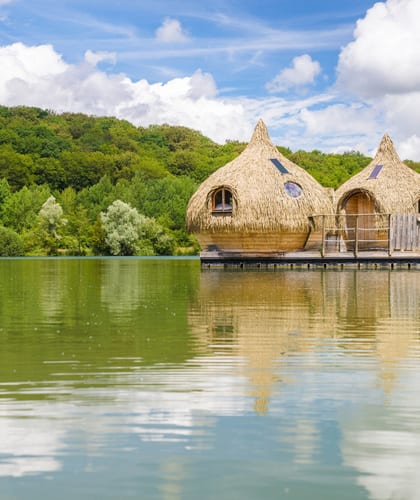 Two flotels on a river with pampas roofs