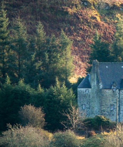 A castle surrounded by Scottish HIghland countryside