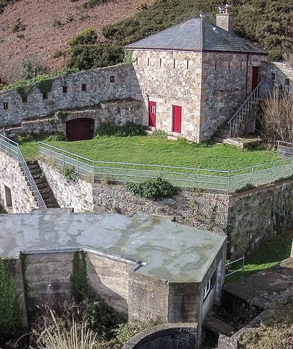 A historic military base converted into holiday accommodation elevated above Jersey's coastline
