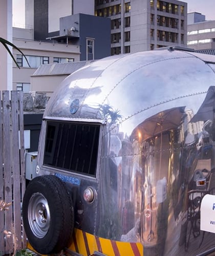 A silver Airstream Trailer on a hotel rooftop in Cape Town
